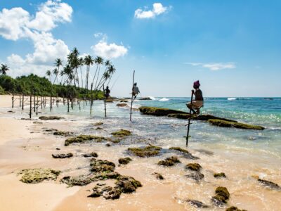 Photo by Daniel Klein group of people climbing on stand beside seashore