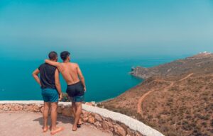 Two men enjoying a scenic view over the coastline of Chefchaouen, Morocco.